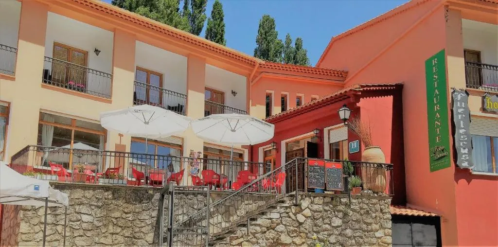 Hotel Fuertescusa entre pinos, con terraza exterior y fachada de piedra